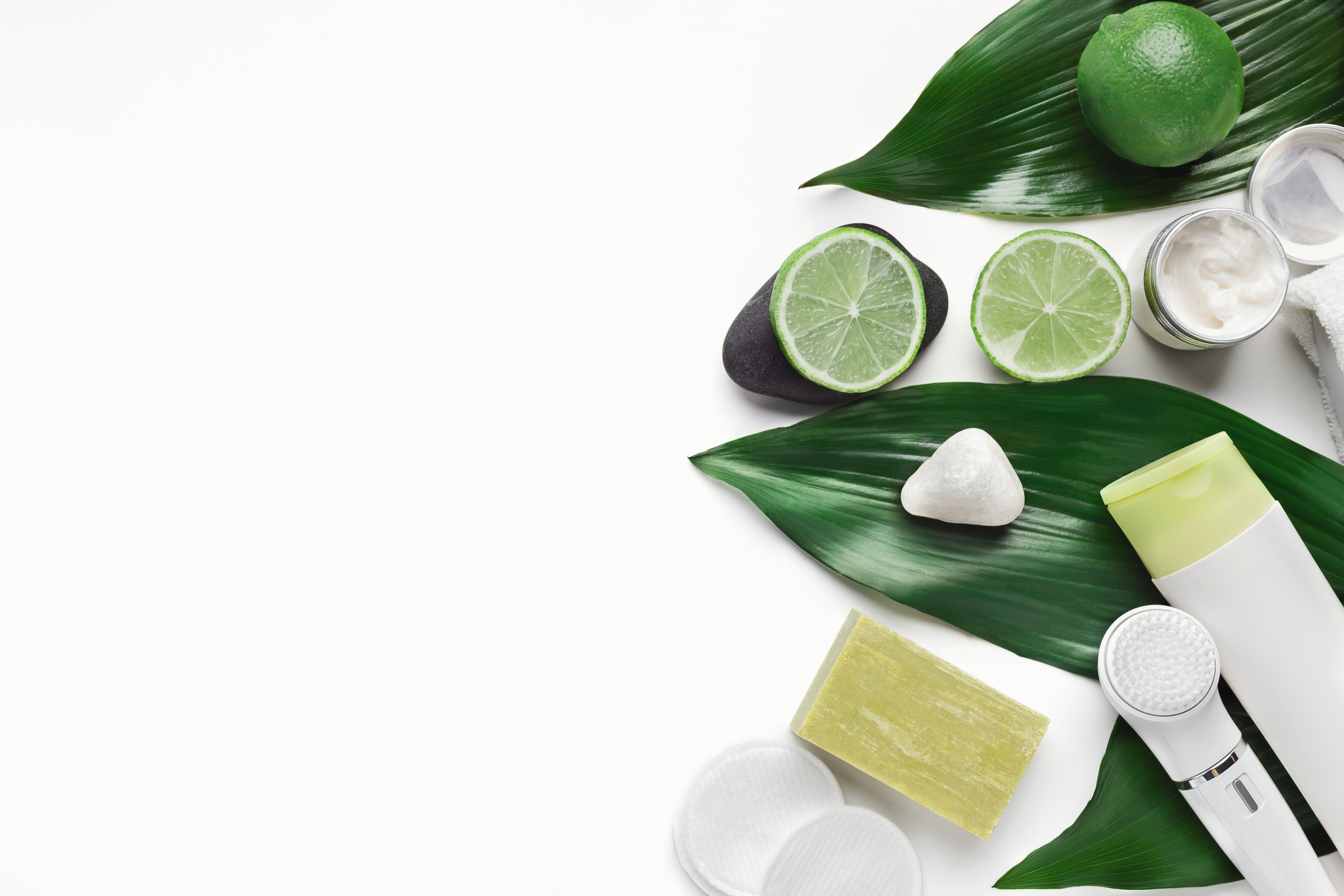 Natural skincare products on big green leaves